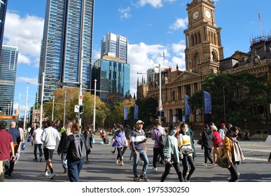 Sydney, NSW, Australia, May 10, 2021. View Of  The Town Hall And People Walking Along George Street On A Sunny Autumn Day