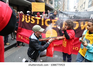 SYDNEY, NSW / AUSTRALIA - May 12, 2018: Smoke Is Blown Toward Protestors At A Demonstration, Calling Attention To Deaths Of Aboriginal People While In Police Custody, Passes Through Sydney's CBD.