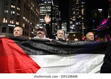 SYDNEY, NSW / AUSTRALIA - May 15, 2018: Four Men Hold A Palestinian Flag At A Demonstration Held To Mark 70 Years Since The Palestinian Exodus (Nakba) In 1948.