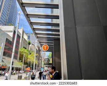 Sydney, NSW, Australia. November 11, 2022. Train Station Sign Outside Wynyard Station And People Walking On The Busy Road.