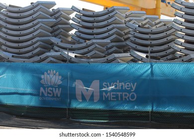 Sydney, NSW  Australia - October 22 2019: Stations Confirmed For Sydney Metro West. Stack Of Precast Concrete Tunnel Segments Behind A Fence With Signage That Reads NSW Government Sydney Metro.