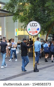 Sydney, NSW / Australia - September 19 2019: Sydney Ugg Boot Manufacturer Ordered To Pay $650,000 For Selling 12 Pairs Of Boots Into The US. Pictured Is A Man Holding A Sign Pointing To The Ugg Store