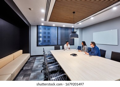 Sydney, NSW/Australia-July 14 2018:Interior Photography Of A Commercial Fit Out Of A Corporate Board Room With A Large Meeting Table And Black Leather Chairs And Staff Members Conducting A Meeting