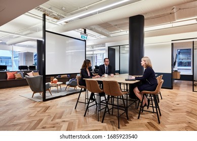 Sydney, NSW/Australia-July 15 2018:Interior Photography Of A Contemporary Design Corporate Office Break Out Area With A Lunch Table & Brown Leather Stools, A White Board And Parquet Flooring & Staff