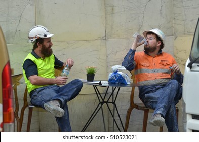 SYDNEY - OCT 20 2016:Two Australian workers having a lunch break in the street in Sydney, New South Wales.Employees can not be asked to work more than 5 hours without a meal break.