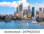 Sydney skyline towering above Circular Quay, New South Wales, Australia - Both a harbour, public esplanade and transport node, it is located along Sydney Cove in the city