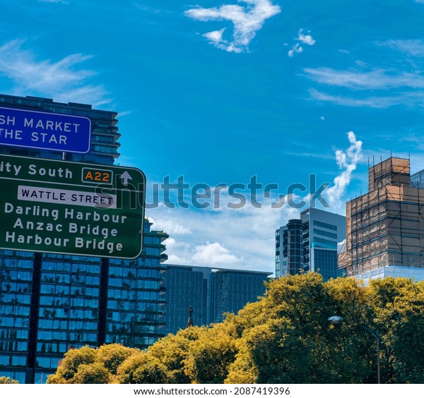 Sydney street signs and buildings with trees,\
NSW, Australia.