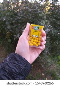 Syktyvkar, Russia - July, 2018. A Donut-flavored Tic-tac Representing Homer Simpson Is Held By A Girl.