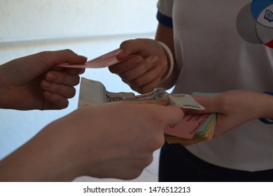 Syktyvkar, Russia - May, 2017. Hands Volunteer Pass Tickets To A Charity Concert For The Money.