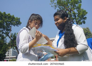 Sylhet, Bangladesh - 14 November 2021: After Giving SSC (secondary School Certificate) Exam, Two Students Are Talking In Front Of The Exam Center With Question Papers In Their Hands.