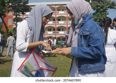 Sylhet, Bangladesh - 14 November 2021: After Giving SSC (secondary School Certificate) Exam, Two Students Are Talking In Front Of The Exam Center With Question Papers In Their Hands.