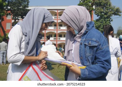 Sylhet, Bangladesh - 14 November 2021: After Giving SSC (secondary School Certificate) Exam, Two Students Are Talking In Front Of The Exam Center With Question Papers In Their Hands.