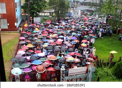 Sylhet, Bangladesh - 20 October 2017: Parents Of Students Wait In Front Of The School Gate With Umbrellas Just Before The End Of A Scholarship Exam On A Rainy Day.