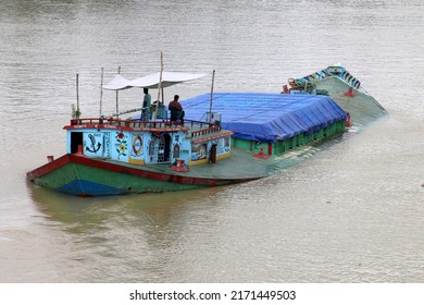 Sylhet, Bangladesh- June 24, 2022: Loaded Steel Body boat or Ship is traveling during flood or overflowing water at Surma River,Sylhet, Bangladesh.