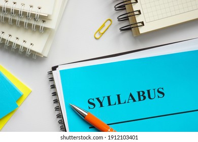 Syllabus educational plan and papers on the desk.