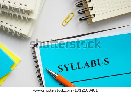 Syllabus educational plan and papers on the desk.