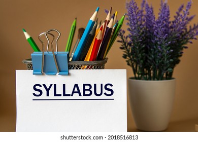 SYLLABUS - word on a white sheet against the background of pencils and a bouquet of lavender. Education concept