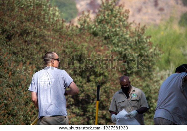 Sylmar, California, United\
States - October 21, 2020: Los Angeles County Parks and Recreation\
workers improve a trail at Veterans Memorial Community Regional\
Park.