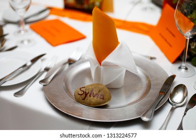 Sylvia Nametag Stone On A Orange Decorated Fully Set Elegant Table