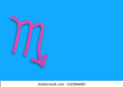 Symbol Of Astrological Sign Scorpio Cut Out Of Purple Paper On Blue Table. Top View. Horoscope Concept. Copy Space For Your Text