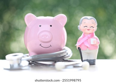 Symbol of breast cancer in women, Womaen and pink ribbon with piggy bank on green background, Healthcare and medicine concept - Powered by Shutterstock