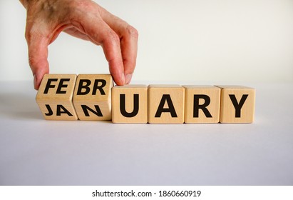 Symbol for the change from January to February. Male hand flips wooden cubes and changes the inscription 'January' to 'February'. Beautiful white background, copy space. - Shutterstock ID 1860660919