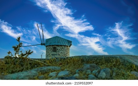 Symbol of the city of Bodrum (Turkey) ancient windmill on a hill. Blue sky with clouds.
