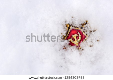The symbol of communism is covered with snow.                             
