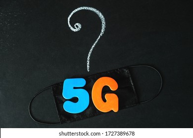 Symbol Of Coronavirus And 5g Network Next To A Medical Mask. The Effect Of 5g Networks On Coronavirus