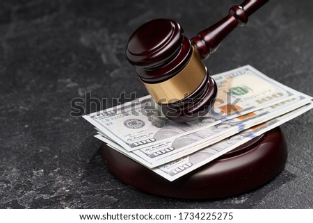Symbol of court and justice, wooden gavel, banknotes on black background,