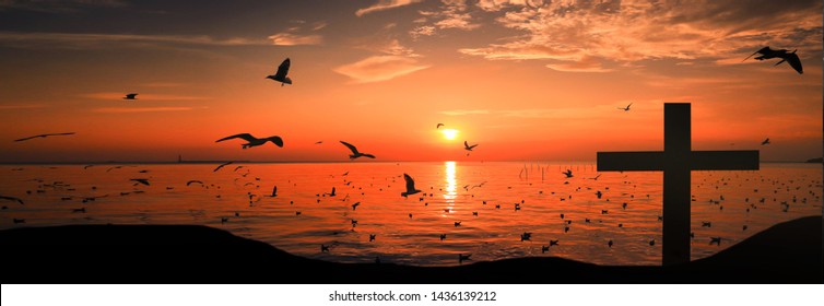 The symbol of the cross of Jesus Christ that appears in the back with evening sunshine and birds that can fly like freedom, such as love, sacrifice, beautiful mercy. - Shutterstock ID 1436139212