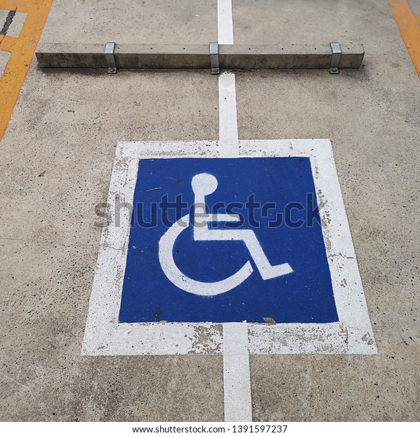 Symbol of disabled\
parking on the road.