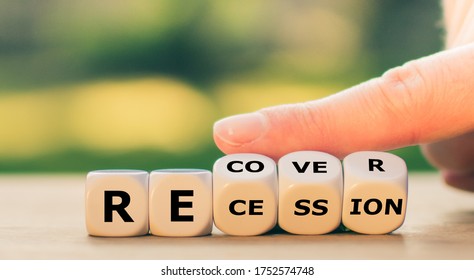 Symbol for the economy after the corona virus. Hand turns dice and changes the word "recession" to "recover". - Shutterstock ID 1752574748