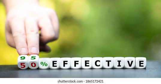 Symbol for the effectiveness of a corona vaccine. Hand turns dice and changes the expression "50% effective" to "95% effective". - Shutterstock ID 1865172421