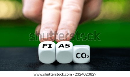 Symbol for failed CO2 reduction. Cubes form the expression 'fiasco' and 'co2'.