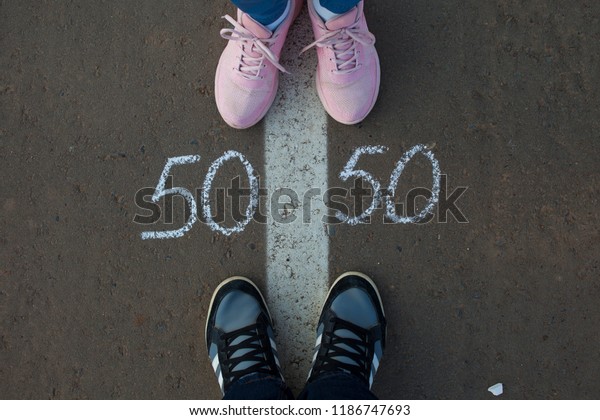 Symbol of gender equality 50/50 on asphalt,\
gender concept