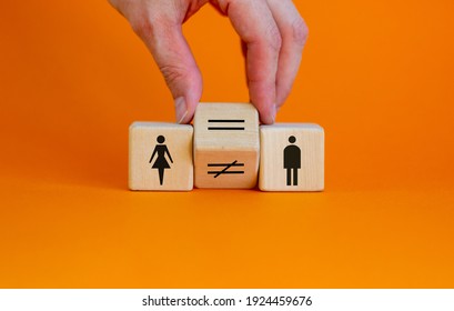 Symbol For Gender Equality. Hand Turns A Cube And Changes A Unequal Sign To A Equal Sign Between Symbols Of Men And Women. Beautiful Orange Background, Copy Space. Gender Equality Concept.