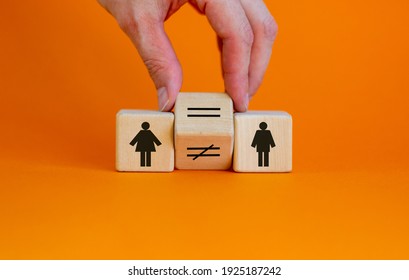 Symbol For Gender Equality. Hand Turns A Cube And Changes A Unequal Sign To A Equal Sign Between Symbols Of Men And Women. Beautiful Orange Background, Copy Space. Gender Equality Concept.