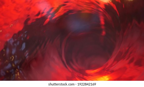 Symbol of hell, inferno and infinity. Red liquid hypnotic aqua swirl turning. Meditative ruby luminous whirlpool. Mesmerising spiral tunnel of crystal fluid. Fiery surreal rhythmic water gradient.