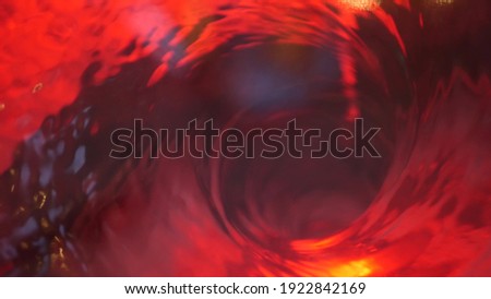 Symbol of hell, inferno and infinity. Red liquid hypnotic aqua swirl turning. Meditative ruby luminous whirlpool. Mesmerising spiral tunnel of crystal fluid. Fiery surreal rhythmic water gradient.
