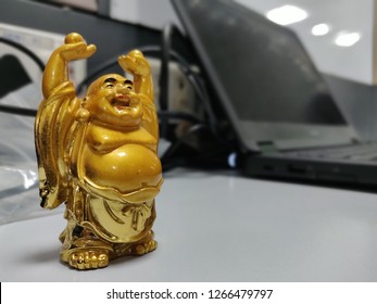 A symbol of joy and well being and vision of happiness,  the Laughing Buddha, just near my Laptop so that I get reminded to cheer up from a busy day schedule. This picture was taken from my office