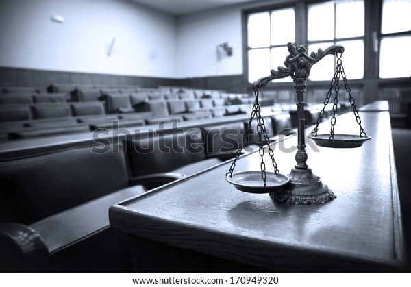 Symbol of law and justice in the empty\
courtroom, law and justice concept, blue\
tone