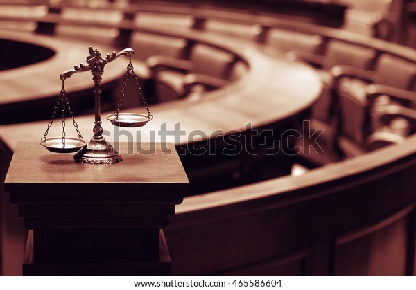Symbol of law and justice in the empty\
courtroom, law and justice\
concept.