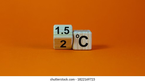 Symbol for limiting global warming. Turned a cube and changed the expression '2 C' to '1.5 C', or vice versa. Concept. Beautiful orange background, copy space. - Shutterstock ID 1822169723