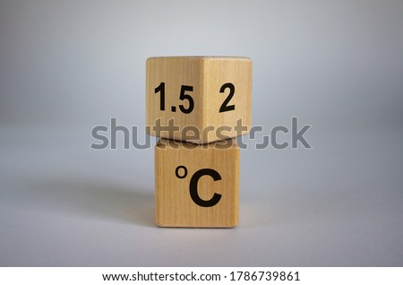 Symbol for limiting global warming. Turned a cube and changed the expression '2 C' to '1.5 C', or vice versa. Concept. Beautiful white background, copy space.