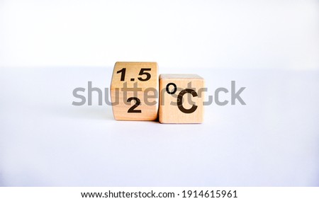 Symbol for limiting global warming. Turned a cube and changed the expression '2 C' to '1.5 C', or vice versa. Concept. Beautiful white background, copy space.