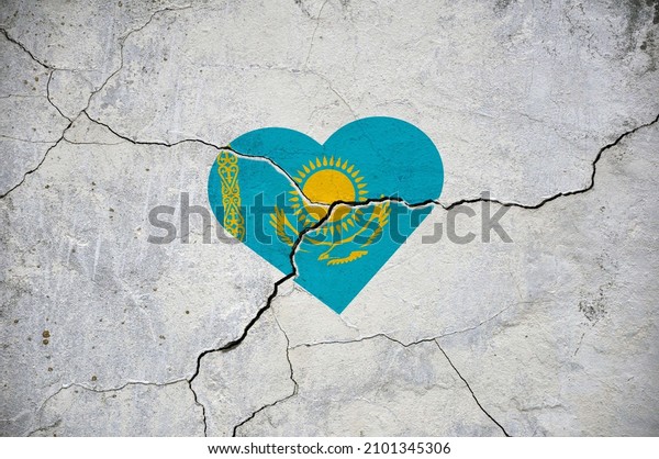 The symbol of the\
national flag of Kazakhstan in the form of a heart on a cracked\
concrete wall. Concept.