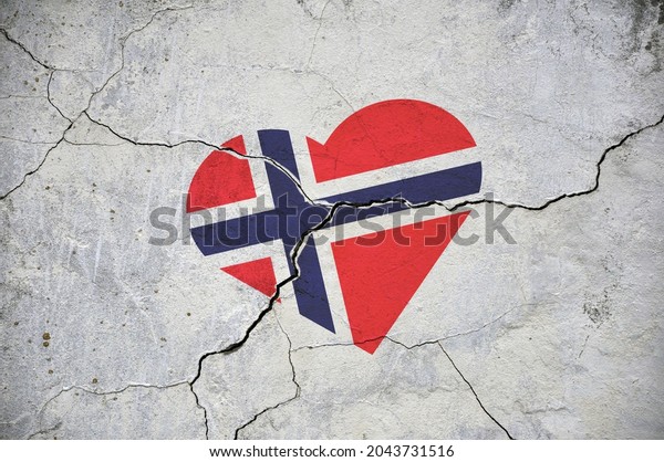 The symbol of the Norway\
national flag in the shape of a heart, on a cracked concrete wall.\
Concept.