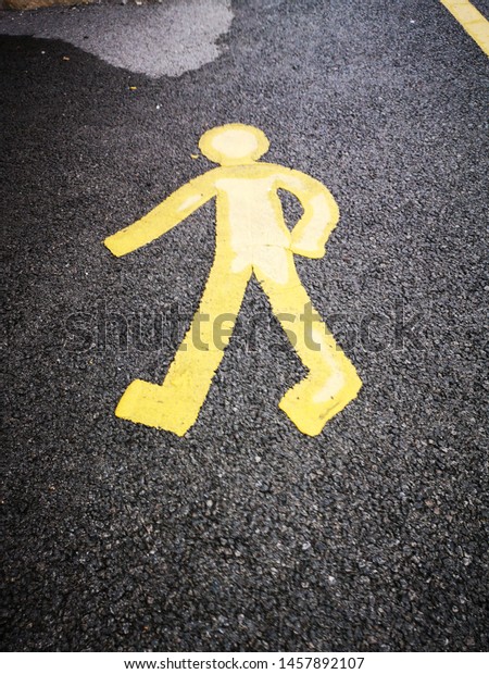 A\
symbol painted on the road to show pedestrian\
walkway