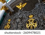 Symbol of the Russian Czaar (2 golden eagles with a crown) on an iron fence at the Winter Palace (The Hermitage museum) in Saint Petersburg in Russia, Europe